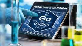 Bild zeigt eine menschliche Hand in einer Laborumgebung die auf ein Display zeigt. Das Display zeigt einen Ausschnitt aus dem periodensystem, im Speziellen die Angaben zum Element Gallium.