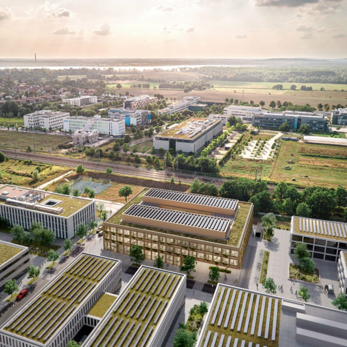 Bild zeigt ein Luftbild mit bestehenden und geplanten Gebäuden im Science Park Potsdam. Man sieht Wohnsiedlungen und ein großes Areal mit Forschungsgebäuden.