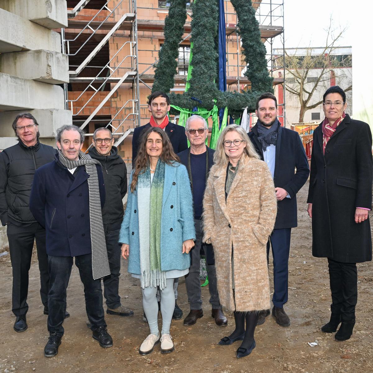 Gruppenbild beim Richtfest in Alt-Britz mit folgenden Personen: v.l.: Ingo Malter, Geschäftsführer STADT UND LAND, Prof. Piero Bruno, IWE Uni Stuttgart, Prof. Eike Roswag-Klinge, Technische Universität Berlin, Sabine Djahanschah, Deutsche Bundesstiftung Umwelt (DBU), Martin Hikel, Bezirksbürgermeister von Neukölln, Dr. Christoph Landerer, Vorsitzender des Aufsichtsrates STADT UND LAND, Ute Bonde, Senatorin für Mobilität, Verkehr, Klimaschutz und Umwelt, Alexander Slotty, Staatssekretär für Bauen, Natascha Klimek, Geschäftsführerin STADT UND LAND. 